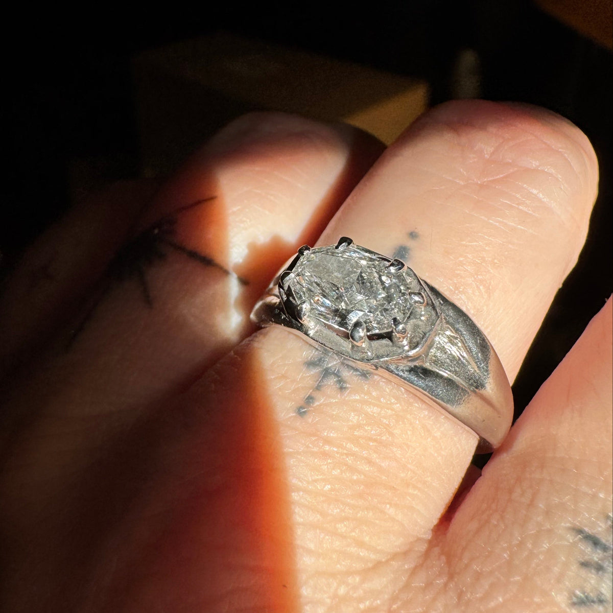 1.48 carat Octagon Diamond Ring in Platinum set in east/west orientation with  micro claw prongs in a faux bezel